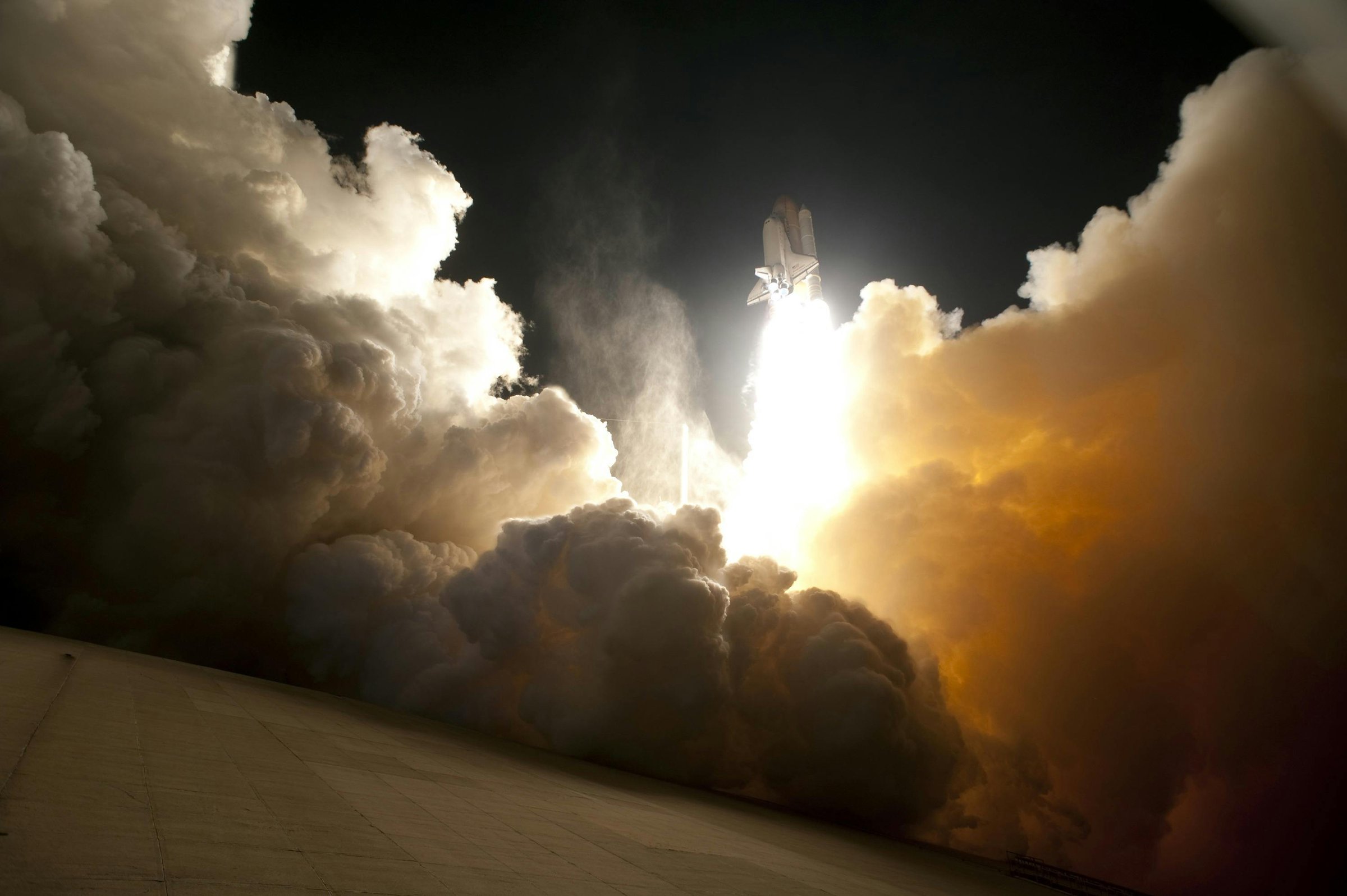 rocket leaving the launch pad at night